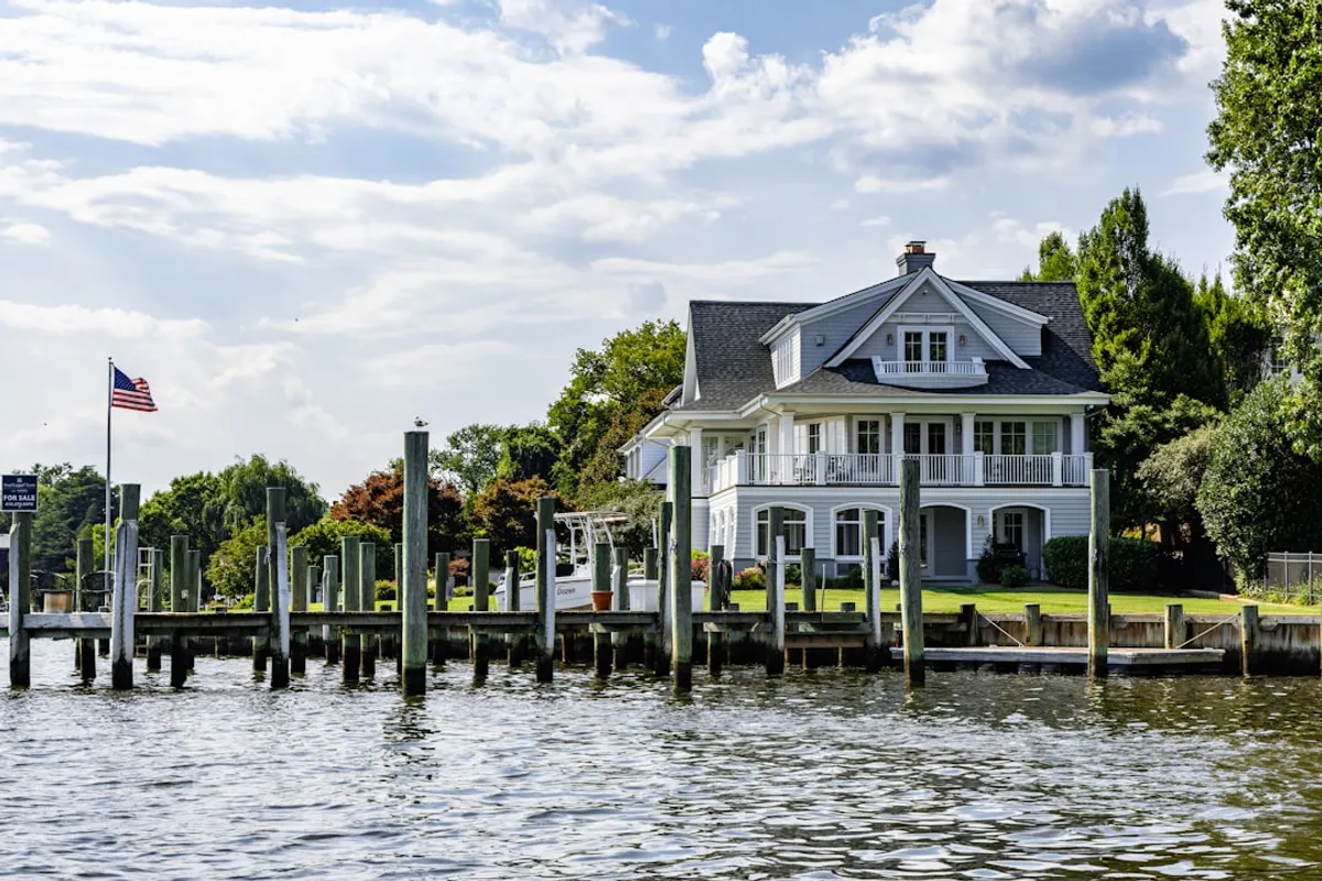 Lakefront residential shoreline with 2-Ton rock bags placed at the waterline, manicured lawn above